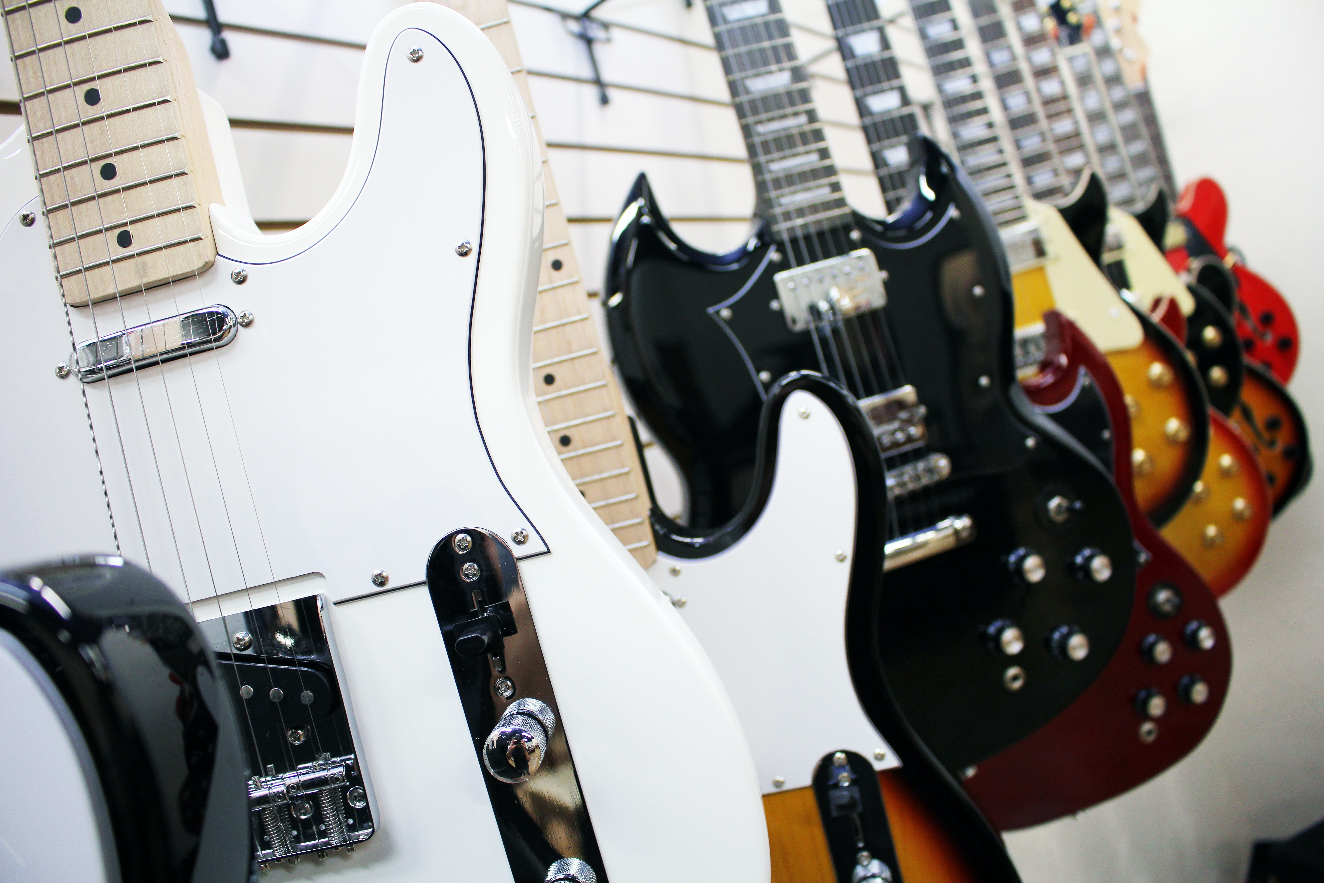 electric guitars on the wall white one first