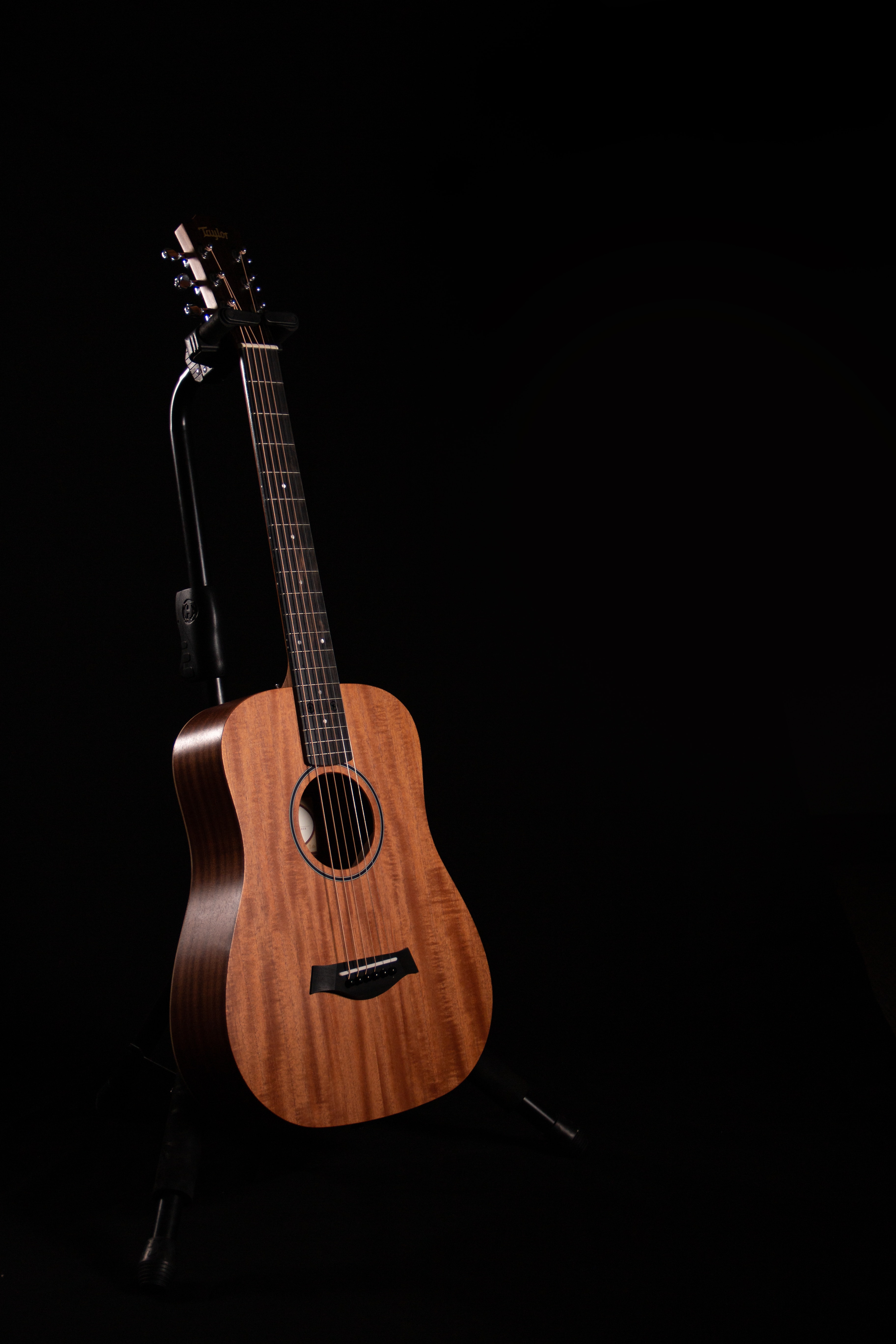 guitar in the dark on a stand